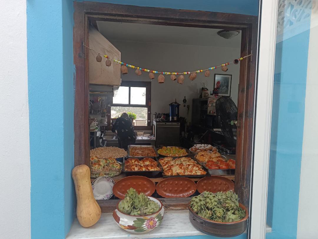 Inside the Ovelistirio Bonenzi kitchen, trays of homemade food on display